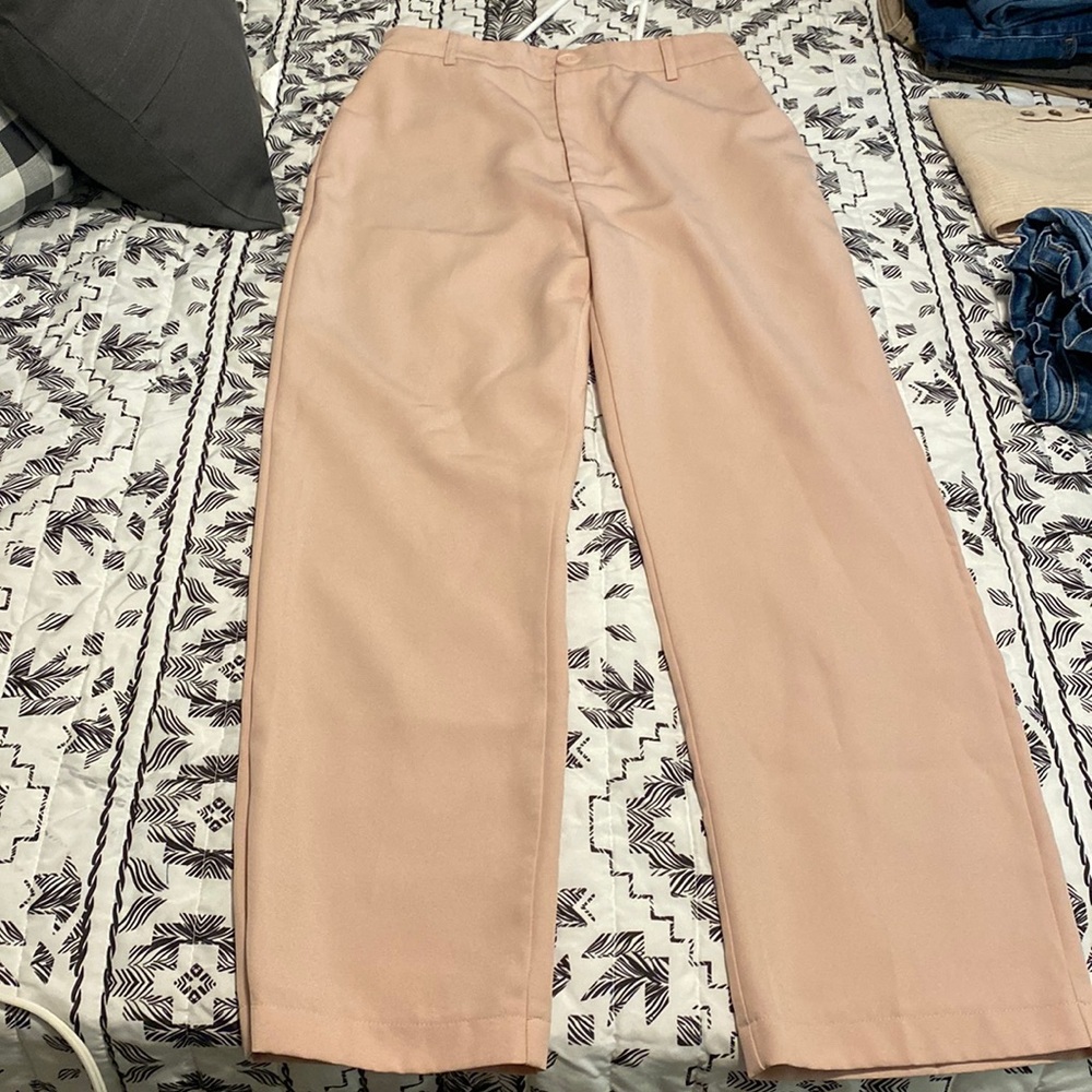 Pale pink dress pants.